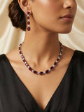 Ruby red CZ tennis necklace and drop earrings bridal set flat lay on black velvet with gold mirror frame and eucalyptus – AureliaBlends