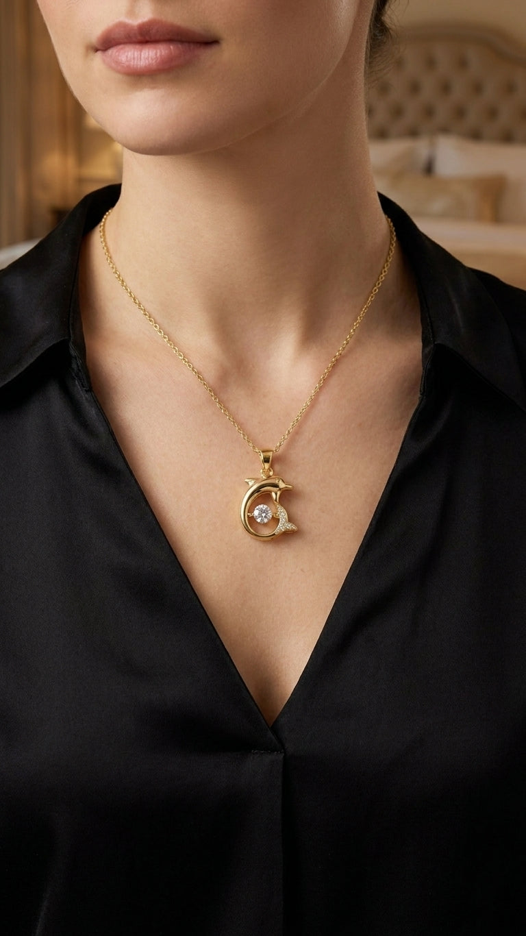 Gold CZ dolphin pendant necklace in open teal velvet gift box with gold satin bow and For You card on wooden table with white roses and baby's breath – AureliaBlends gift for her
