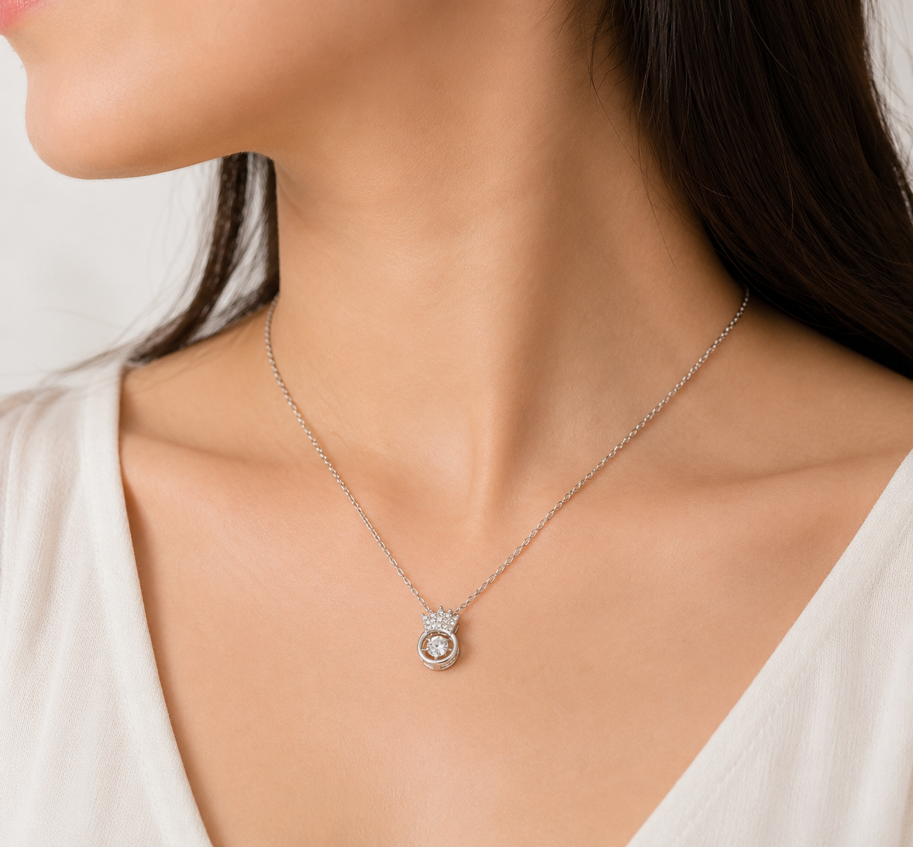 Silver CZ crown orbital floating pendant necklace on black leather surface with black hexagonal jewelry box – AureliaBlends statement necklace dark editorial