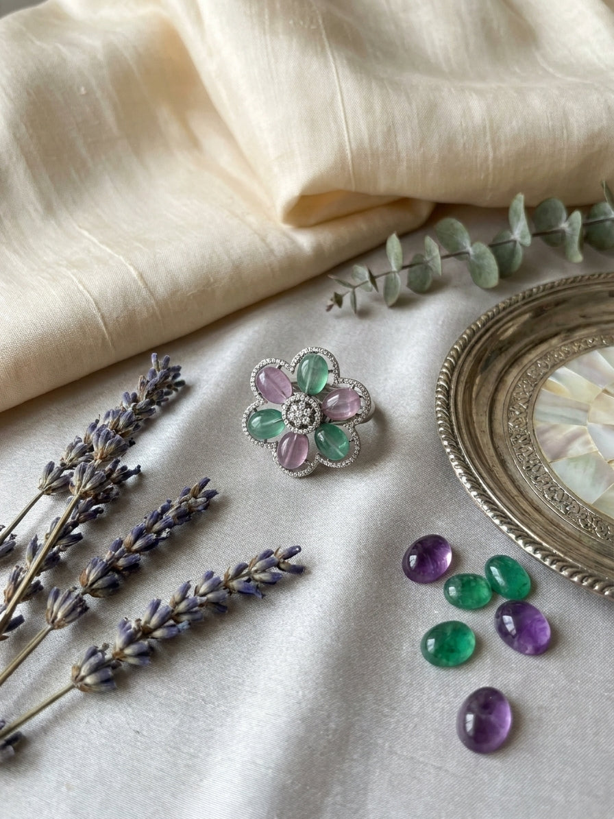 Green aventurine and pink rose quartz floral cocktail ring in silver CZ scalloped setting flat lay on cream silk fabric with lavender sprigs green and purple stone cabochons and silver mirror tray – AureliaBlends