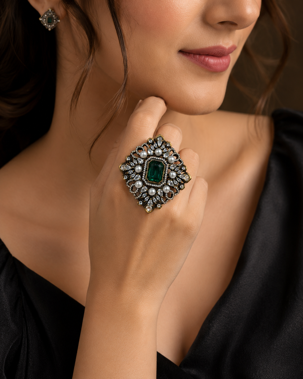 Antique gold Mughal filigree cocktail ring with sapphire blue emerald-cut centre stone pearl cabochons and pear CZ stones flat lay on champagne cream satin with baby breath and gold tray – AureliaBlends