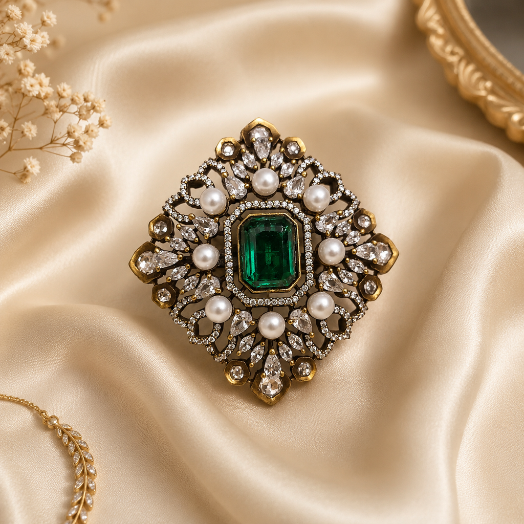 Antique gold Mughal filigree cocktail ring with crystal white emerald-cut centre stone pearl cabochons and pear CZ stones flat lay on champagne cream satin with baby breath and gold chain – AureliaBlends