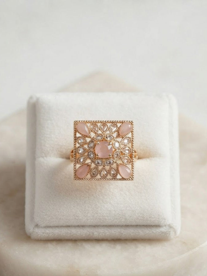 Rose gold square filigree cocktail ring with pink opal teardrop cabochons and round CZ stones flat lay on white background showing full ornate floral lattice design – AureliaBlends