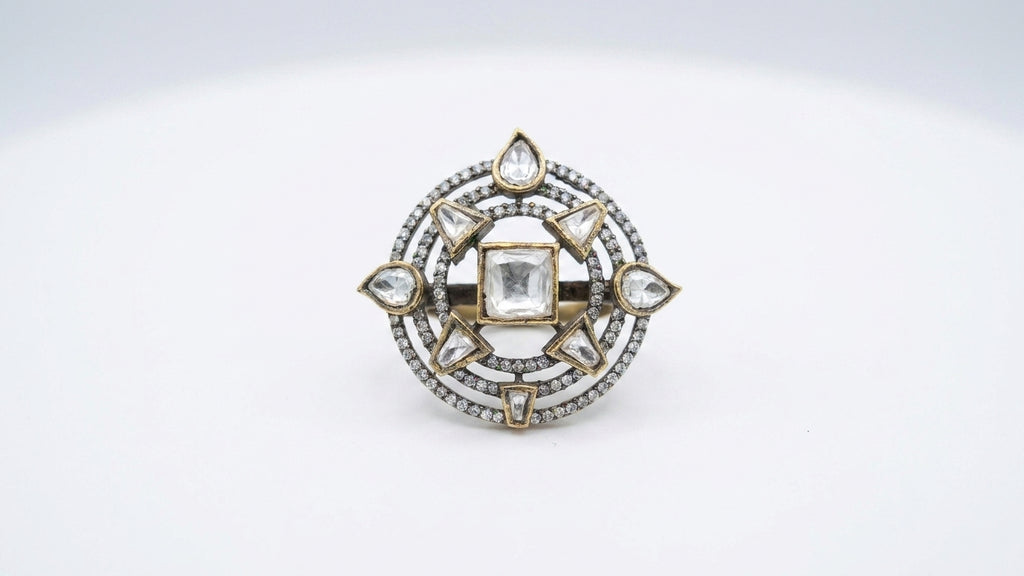 Gold antique polki cocktail ring with square polki centre stone and triangular pear polki compass star design displayed in open dark green velvet luxury jewelry box with gold satin ribbon and With Love gift card on dark wooden table with baby breath flowers – AureliaBlends