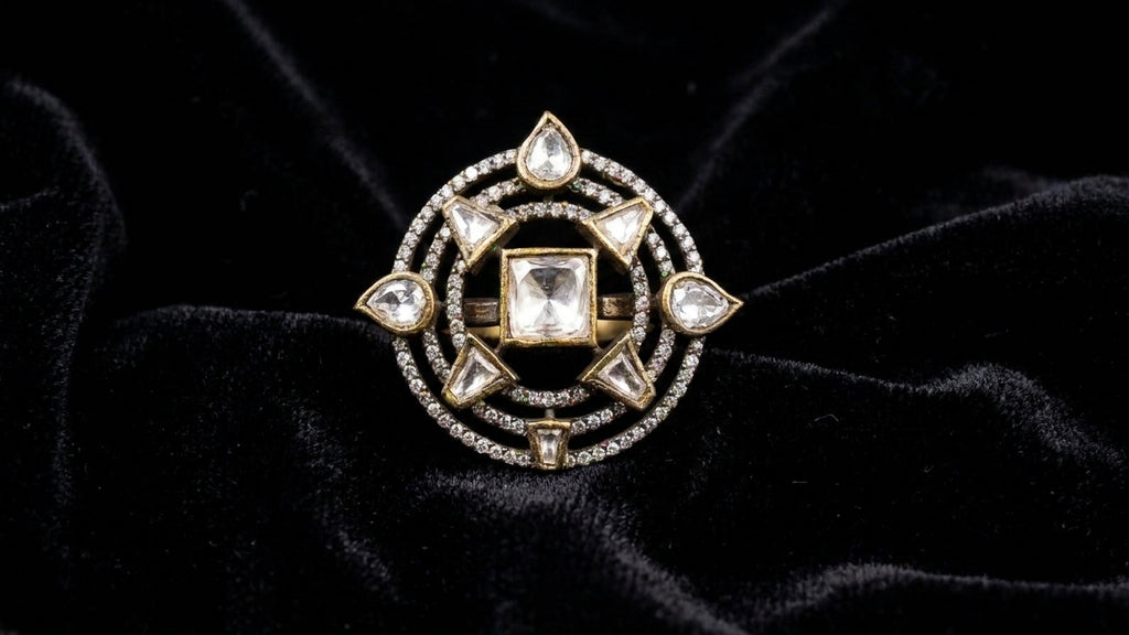 Indian woman wearing gold antique polki cocktail statement ring with square polki centre stone and compass star design on index finger on cream silk satin fabric with neutral manicure – AureliaBlends