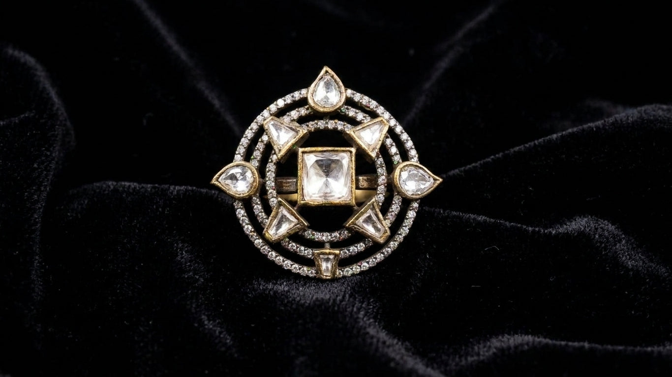 Indian woman wearing gold antique polki cocktail statement ring with square polki centre stone and compass star design on index finger on cream silk satin fabric with neutral manicure – AureliaBlends