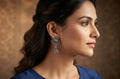 Woman wearing oxidized silver peacock jhumka earrings with navy blue kurta – ethnic dangle drop earrings by AureliaBlends