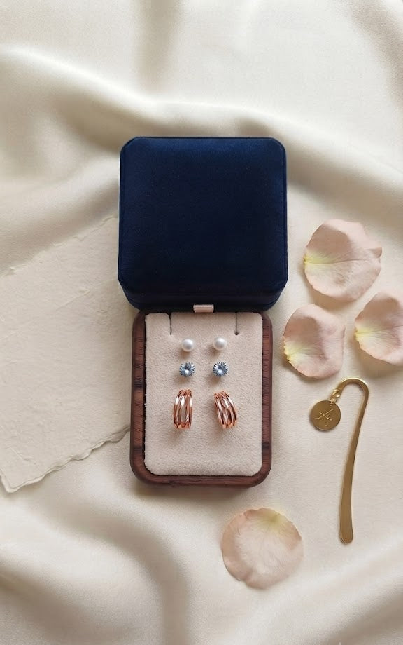 AureliaBlends 3-pair earring set lifestyle flat lay with curated collection card and navy gift box
