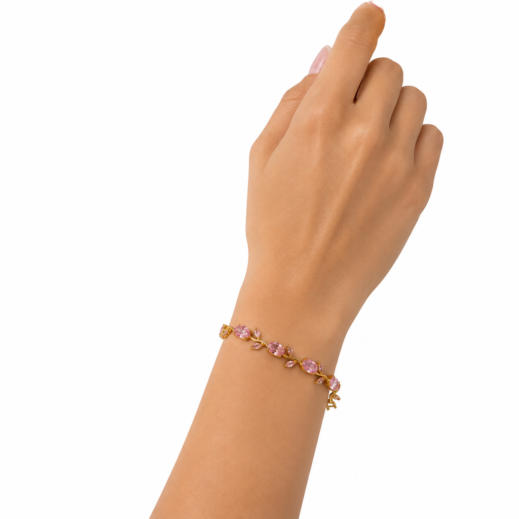 Woman wearing gold-plated rose pink CZ floral vine statement bracelet on wrist on white background – AureliaBlends