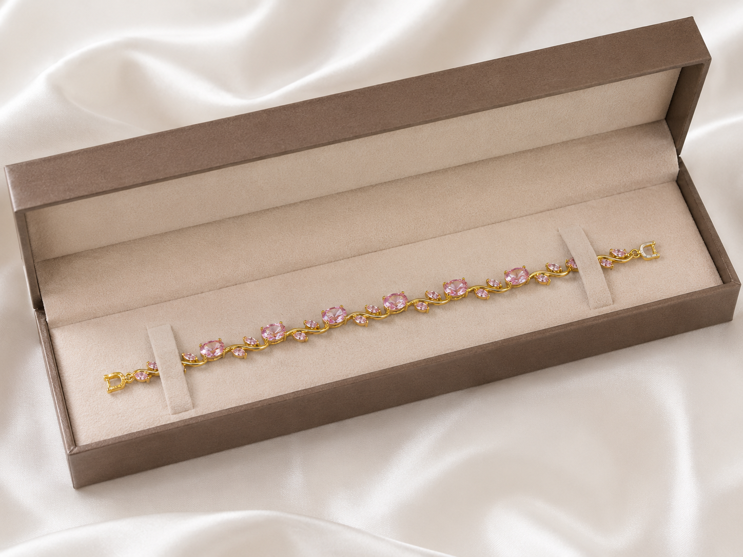 Gold-plated rose pink oval and marquise CZ floral vine bracelet flat lay on cream silk with dried gypsophila – AureliaBlends