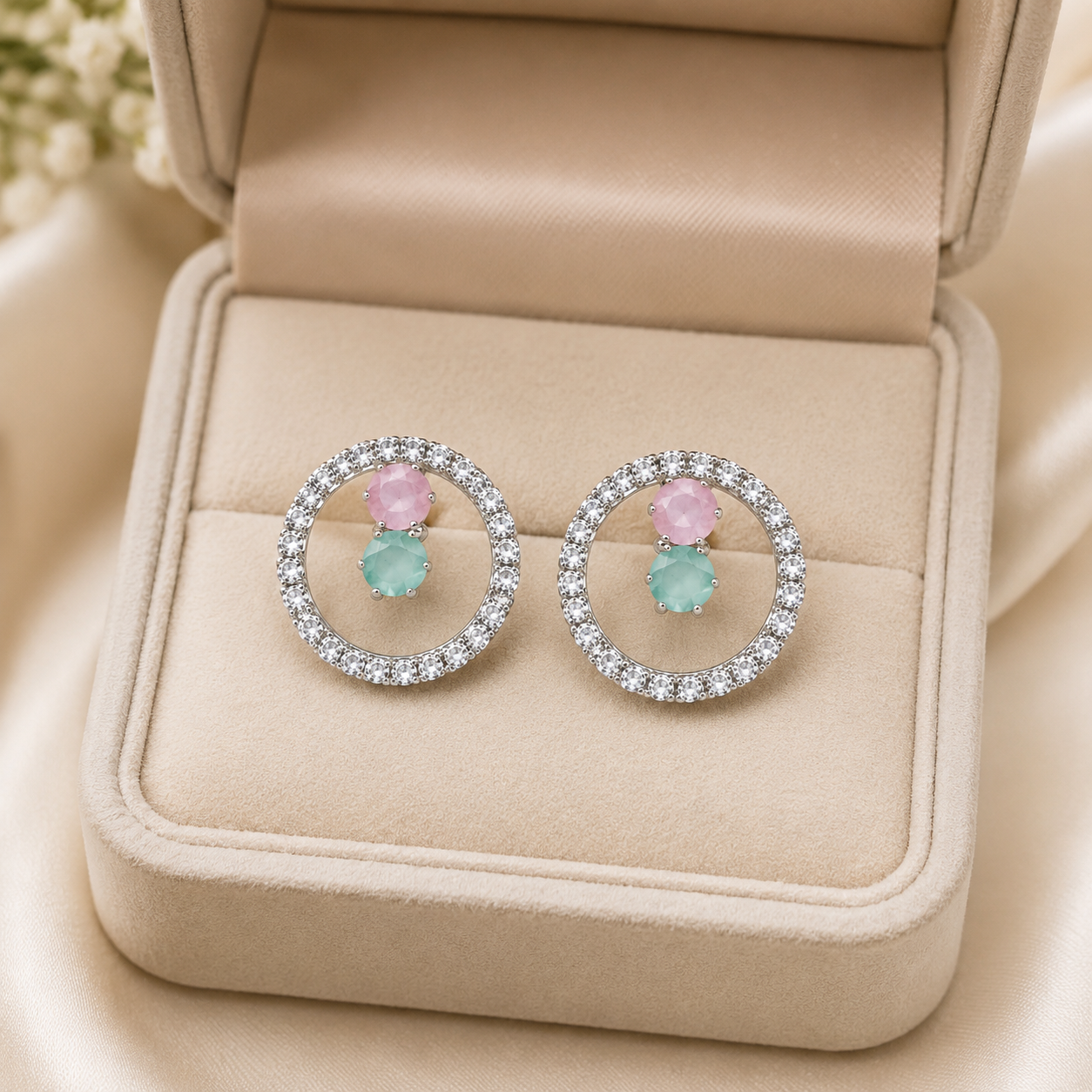 Pink and mint crystal circle stud earrings on black satin jewellery box with gold floral branches – AureliaBlends luxury earrings