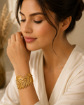 Gold feather wide cuff bracelet on black velvet with red roses – AureliaBlends luxury evening jewelry