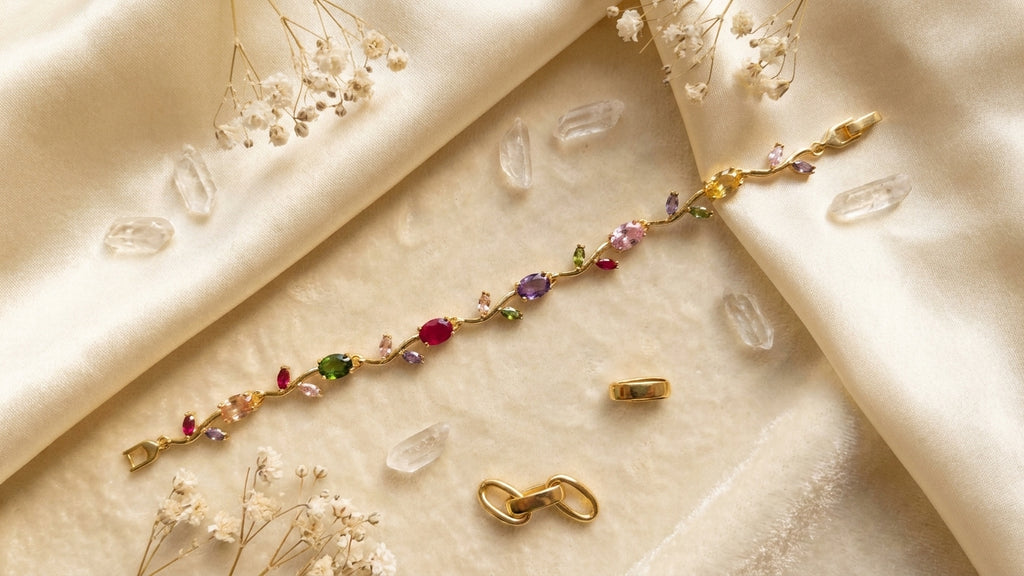 Woman wearing gold-plated multicolour CZ floral vine statement bracelet on wrist in white shirt – AureliaBlends