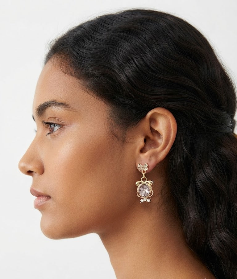 Gold bow and crystal pendant drop earrings in open cream velvet box on white marble with scattered CZ stones and 'For You With Love' card – AureliaBlends gift earrings