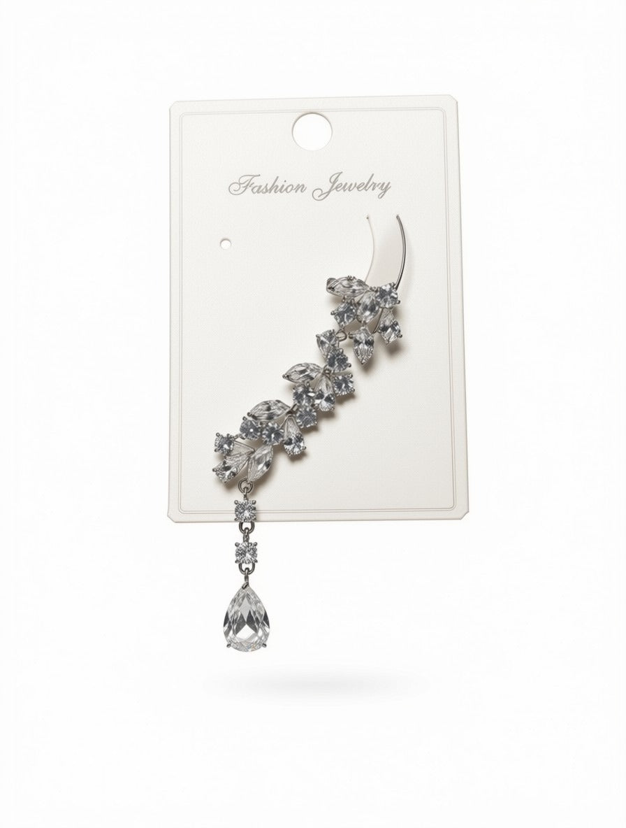 A silver-toned earring with a curved top and a dangling teardrop crystal charm, displayed on a white card labeled 'Fashion Jewelry' against a white background.