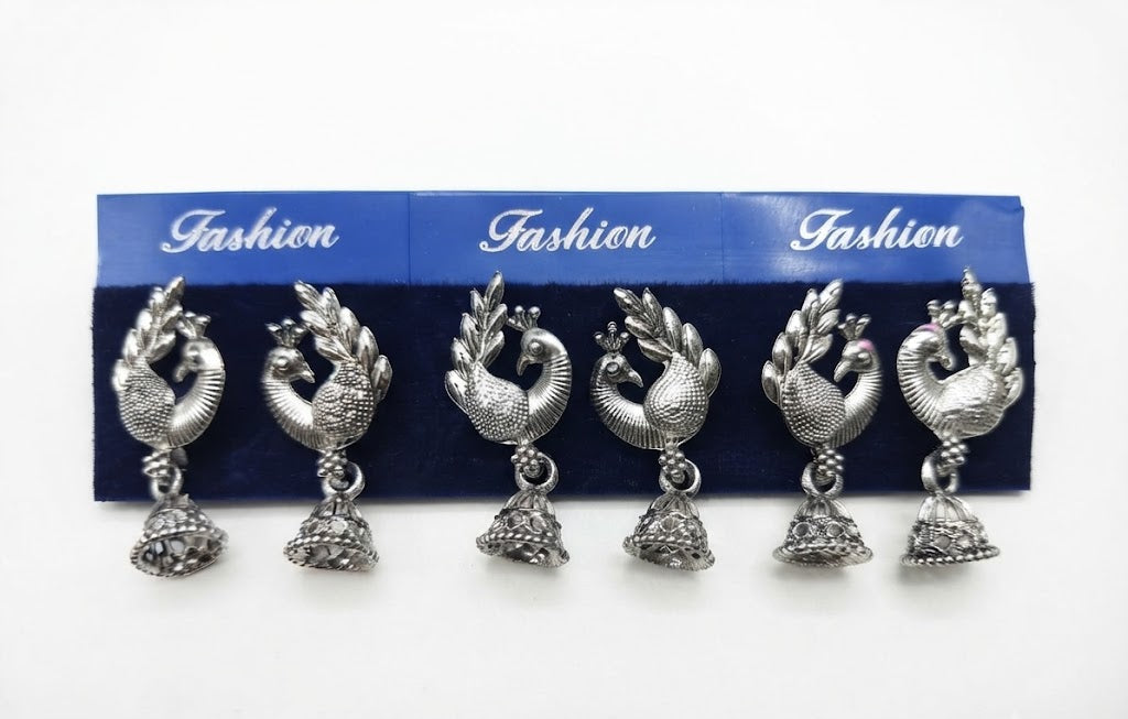 Three pairs of oxidized silver peacock jhumka earrings on blue fashion display card – handcrafted Indian ethnic dangle earrings by AureliaBlends
