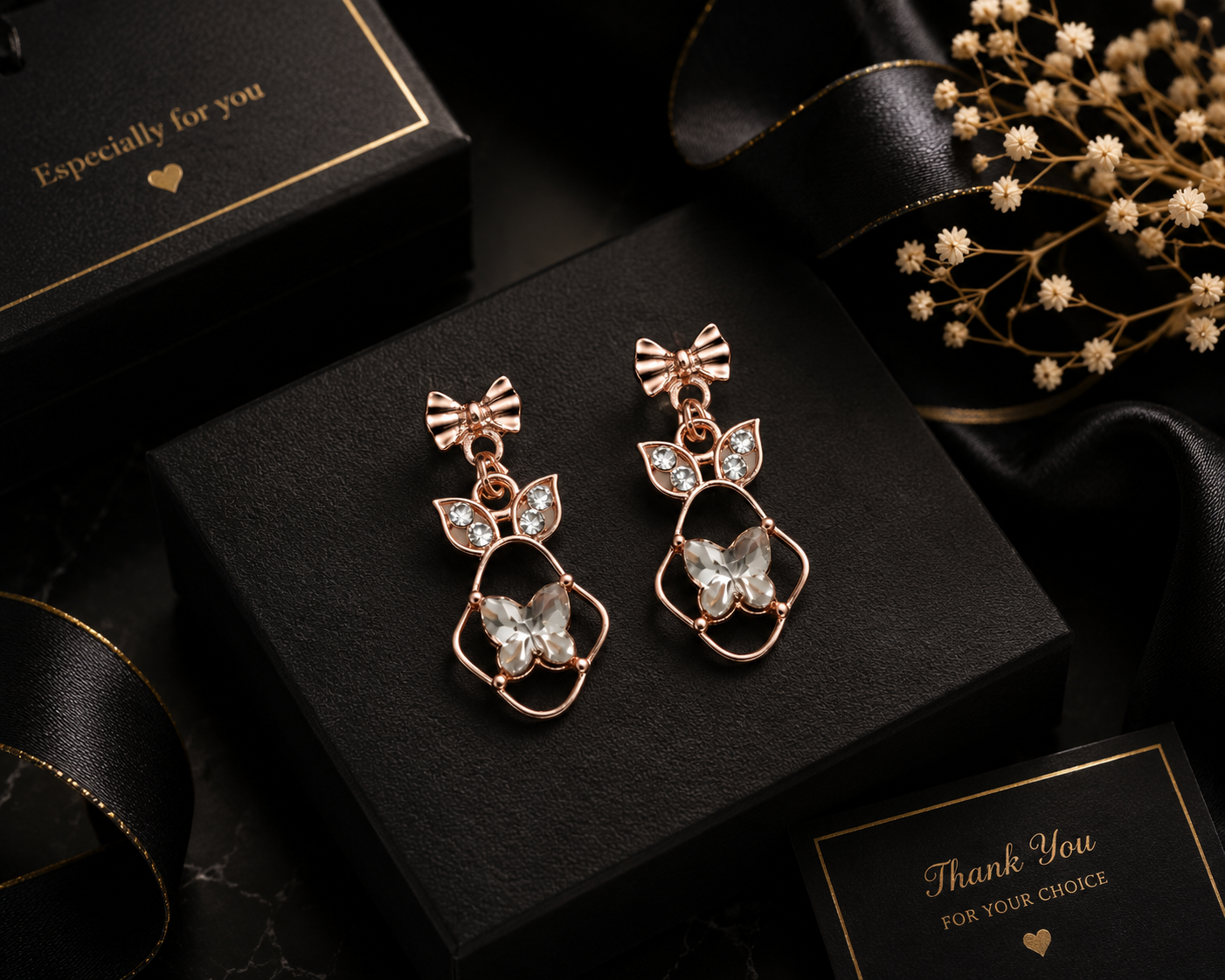 Close-up of rose gold ribbed bow stud, CZ leaf connector and faceted crystal butterfly pendant in open floral frame – AureliaBlends chandelier earrings