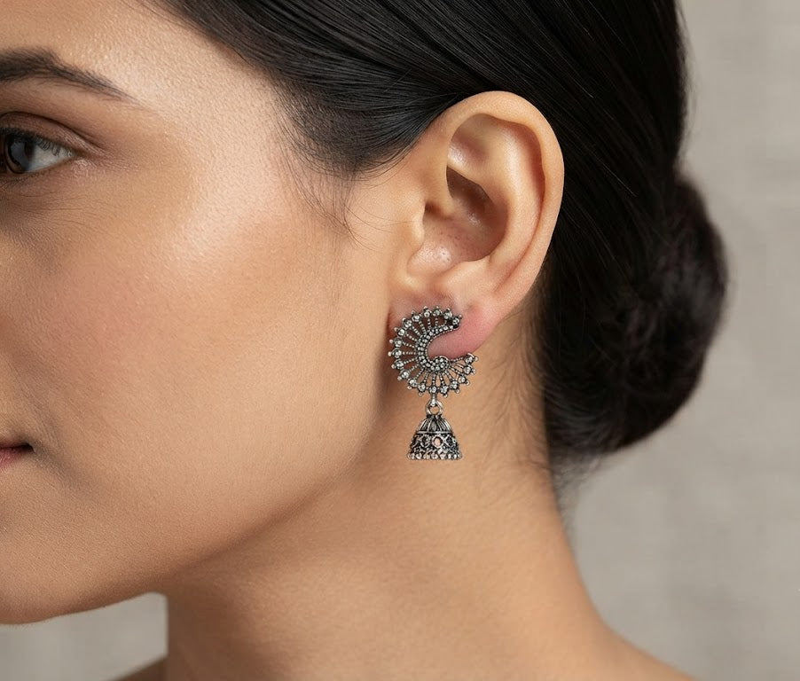 Model wearing oxidized silver crescent peacock jhumka earrings with sleek bun hairstyle – Indian filigree fan drop earrings by AureliaBlends