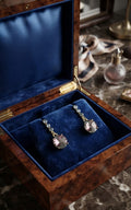 Model wearing gold CZ chain and blush mauve rivoli crystal drop earrings with sleek updo – AureliaBlends dangle earrings for bridal and evening wear