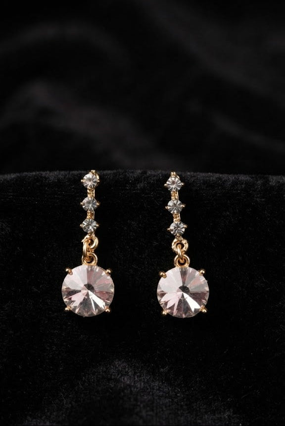Gold CZ chain and blush rivoli crystal drop earrings on white lace with pink roses and lavender flowers – AureliaBlends romantic bridal jewellery