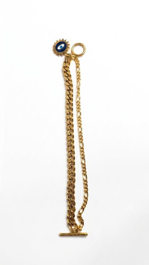 Woman wearing gold-plated evil eye dual chain charm bracelet with toggle clasp on wrist – AureliaBlends