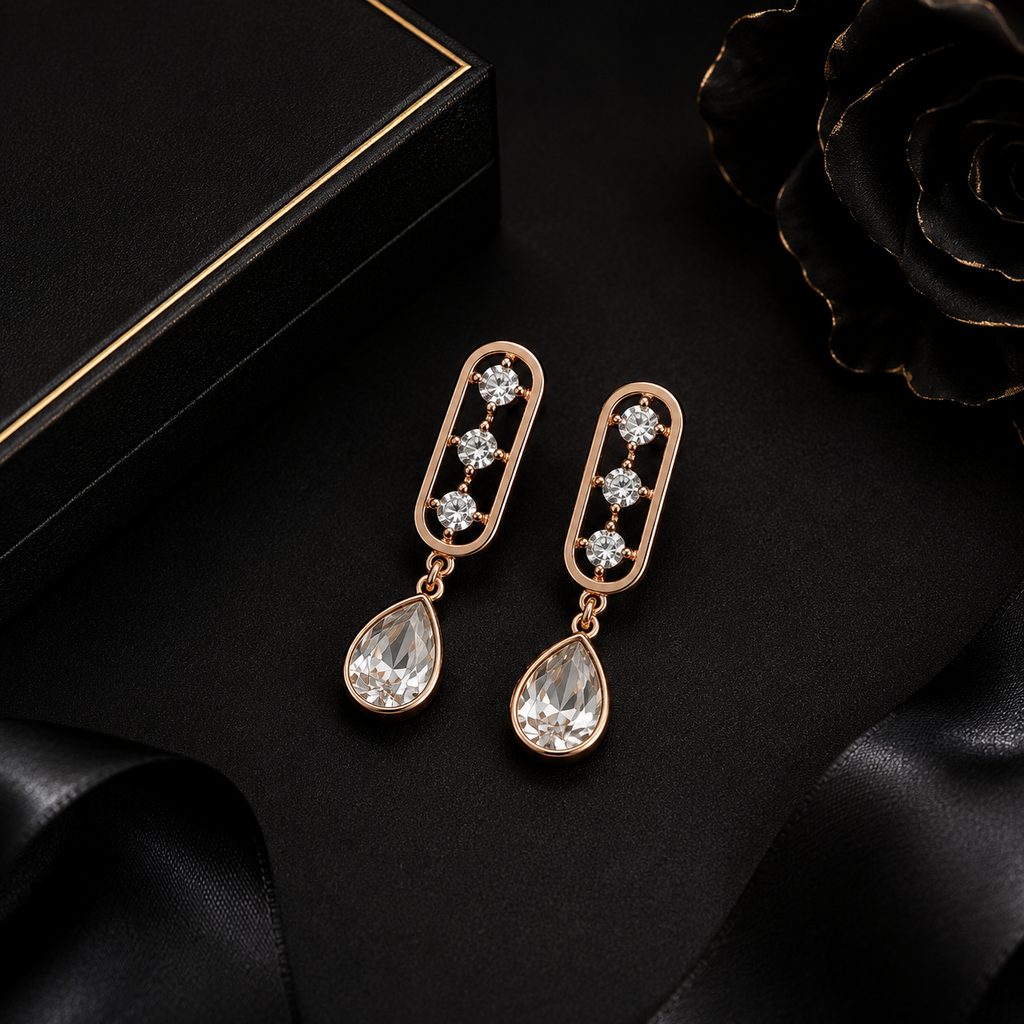 Close-up of rose gold open oval bar stud with three CZ stones and large faceted clear teardrop crystal pendant – AureliaBlends dangle earrings