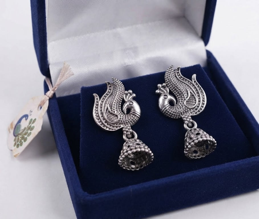 Three pairs of oxidized silver phoenix bird jhumka earrings on navy blue fashion display card – handcrafted Indian ethnic drop earrings AureliaBlends
