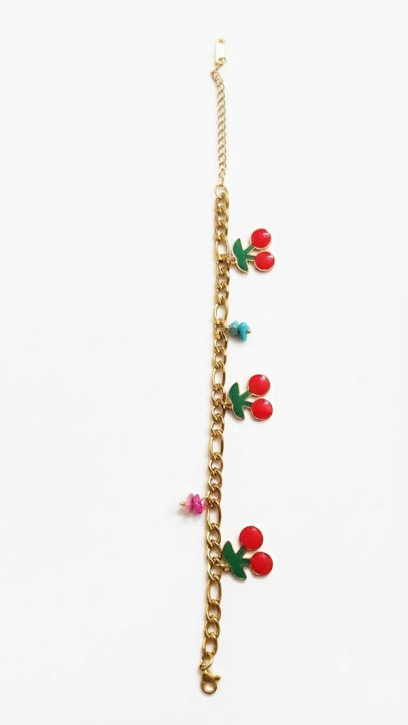 Gold-plated figaro chain cherry enamel charm bracelet on white background – AureliaBlends