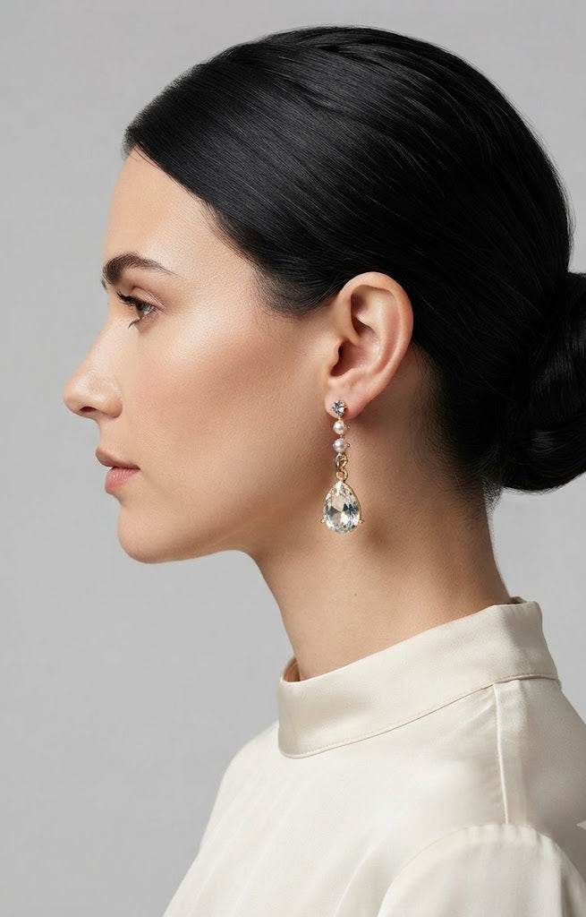 Model with sleek low bun wearing gold CZ stud pearl chain and teardrop crystal drop earrings – AureliaBlends bridal jewellery
