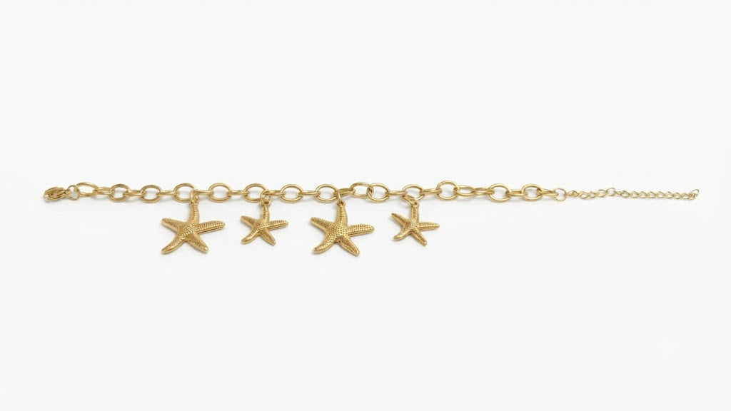 Gold-plated starfish charm bracelet on white background showing oval link chain and lobster clasp – AureliaBlends