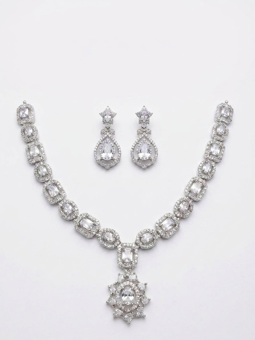 Silver cubic zirconia bridal necklace and drop earring set styled on green velvet with baby's breath flowers and vintage postcards – AureliaBlends