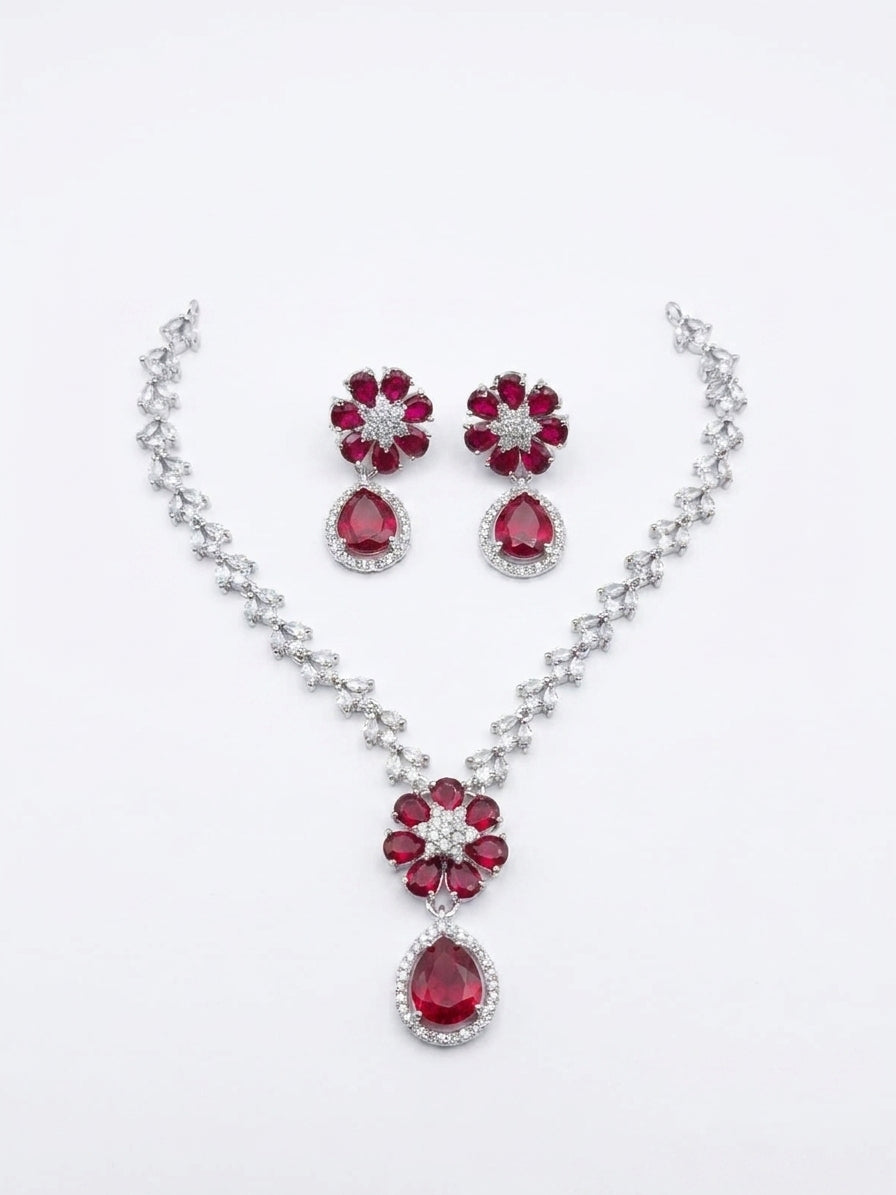 Ruby red cubic zirconia floral bridal necklace and drop earring set on white background – AureliaBlends statement wedding jewelry