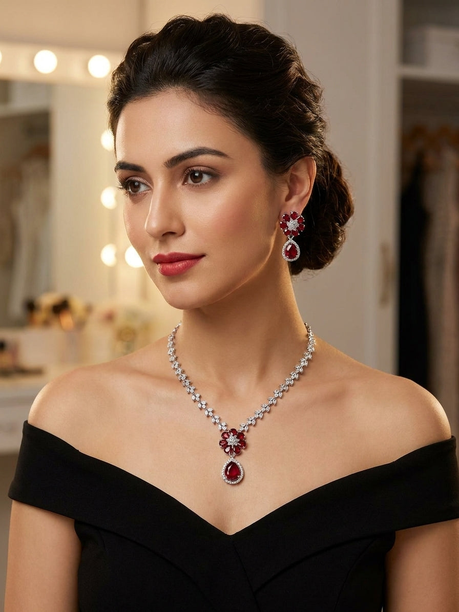 Model wearing ruby red CZ floral pendant necklace and matching drop earrings with a black off-shoulder gown – AureliaBlends bridal jewelry