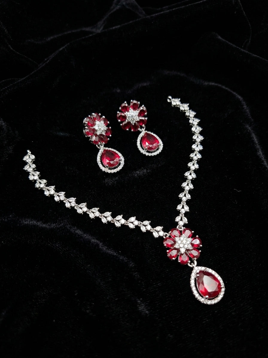 Ruby red CZ floral bridal necklace and drop earring set on black velvet background – AureliaBlends statement jewelry