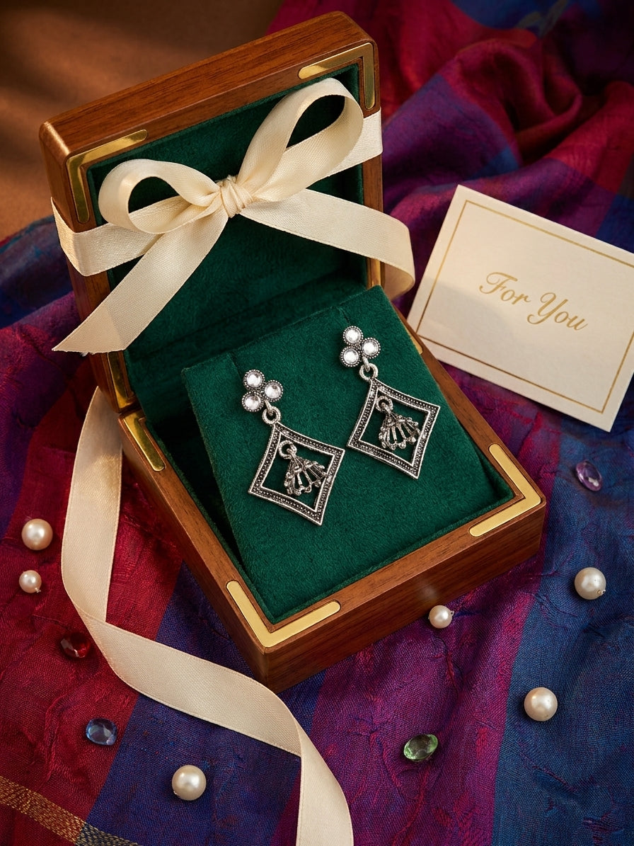 Oxidised silver pearl and jhumka diamond frame drop earrings editorial flat lay on black velvet with scattered black and silver pearls – AureliaBlends ethnic dangle earrings