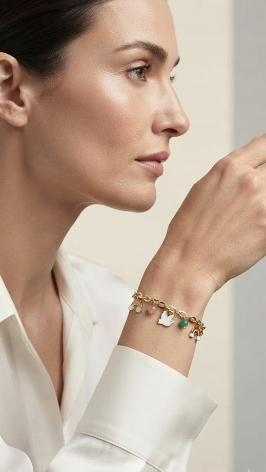 Gold-plated rainbow charm bracelet displayed in wooden luxury jewelry box on navy velvet – AureliaBlends