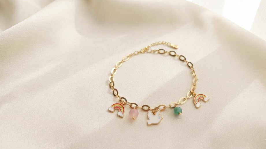 Gold rainbow dove charm bracelet displayed in navy blue luxury gift box with message card and roses – AureliaBlends