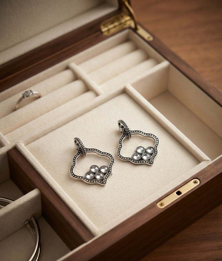 Oxidised silver open quatrefoil Mughal arch frame and pearl cluster drop earrings on dark black velvet background – AureliaBlends antique ethnic earrings