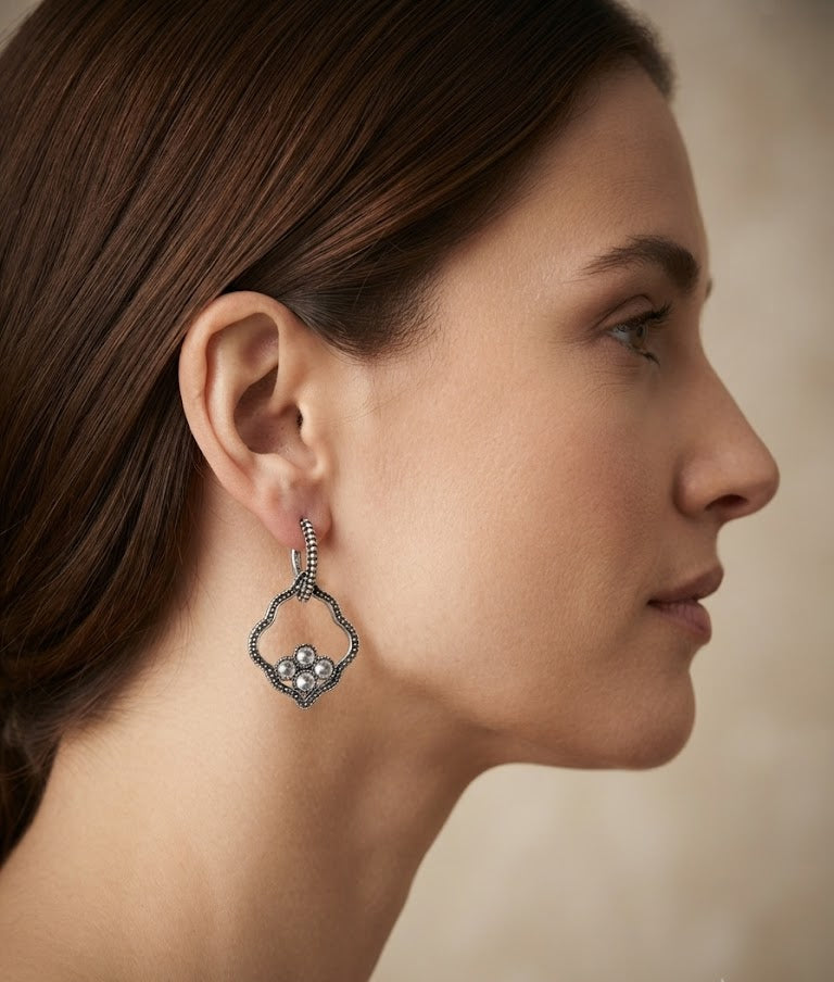 Oxidised silver quatrefoil pearl cluster drop earrings in open walnut wood gift box with purple velvet lining on jewel-toned embroidered fabric – AureliaBlends festive ethnic earrings