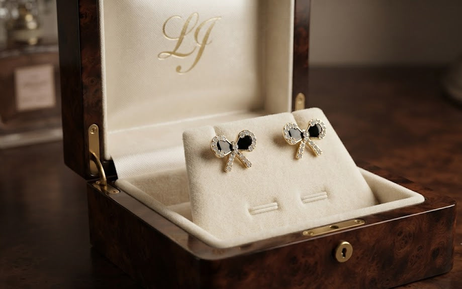 Model wearing gold pavé CZ black bow stud earrings with a sleek dark updo in a warm interior setting – AureliaBlends Timeless Elegance Collection side profile