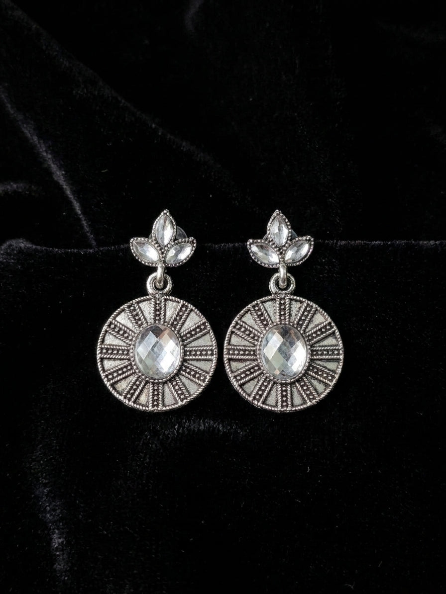Oxidised silver marquise leaf trefoil stud and engraved disc drop earrings with clear crystal stones close-up on cream background – AureliaBlends ethnic dangle earrings detail