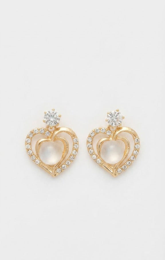 Gold CZ open heart moonstone drop earrings displayed in an open cream velvet walnut jewellery box on a marble surface with a perfume bottle in the background – AureliaBlends