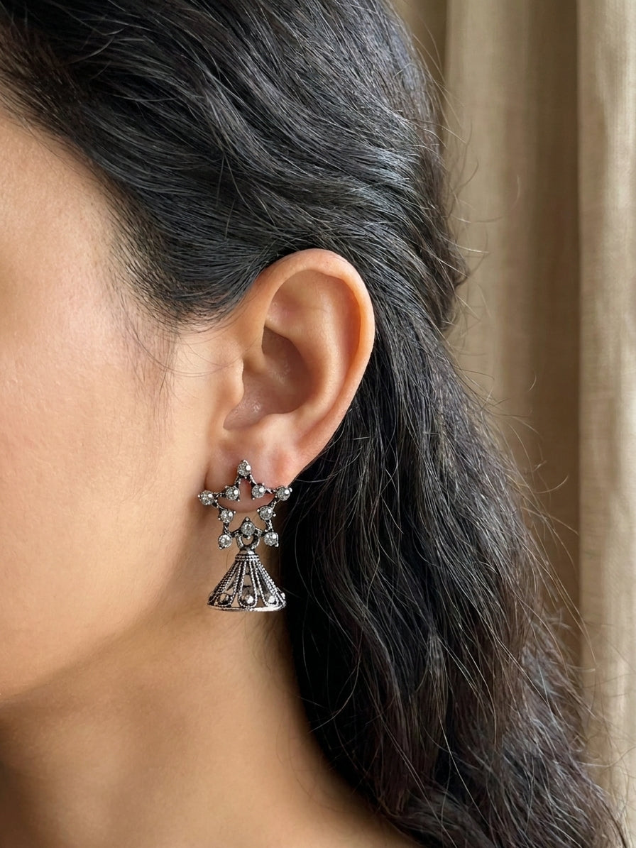 Oxidised silver CZ star and filigree jhumka bell drop earrings editorial flat lay on teal velvet with lavender sprigs, baroque pearls, vintage book, gold jewellery tools and floral teacup – AureliaBlends