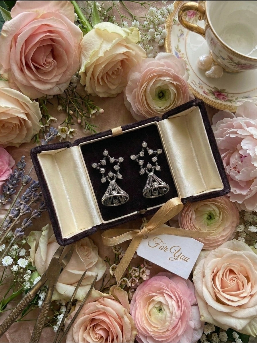 AureliaBlends oxidised silver CZ star pavé and filigree jhumka bell drop earrings lifestyle editorial flat lay on teal velvet with vintage teacup, lavender, baroque pearls and antique book