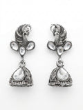 Oxidised silver peacock head CZ kundan trefoil and conical jhumka bell drop earrings in open dark mahogany wood jewellery box with navy blue velvet lining and gold crown logo – AureliaBlends ethnic earrings
