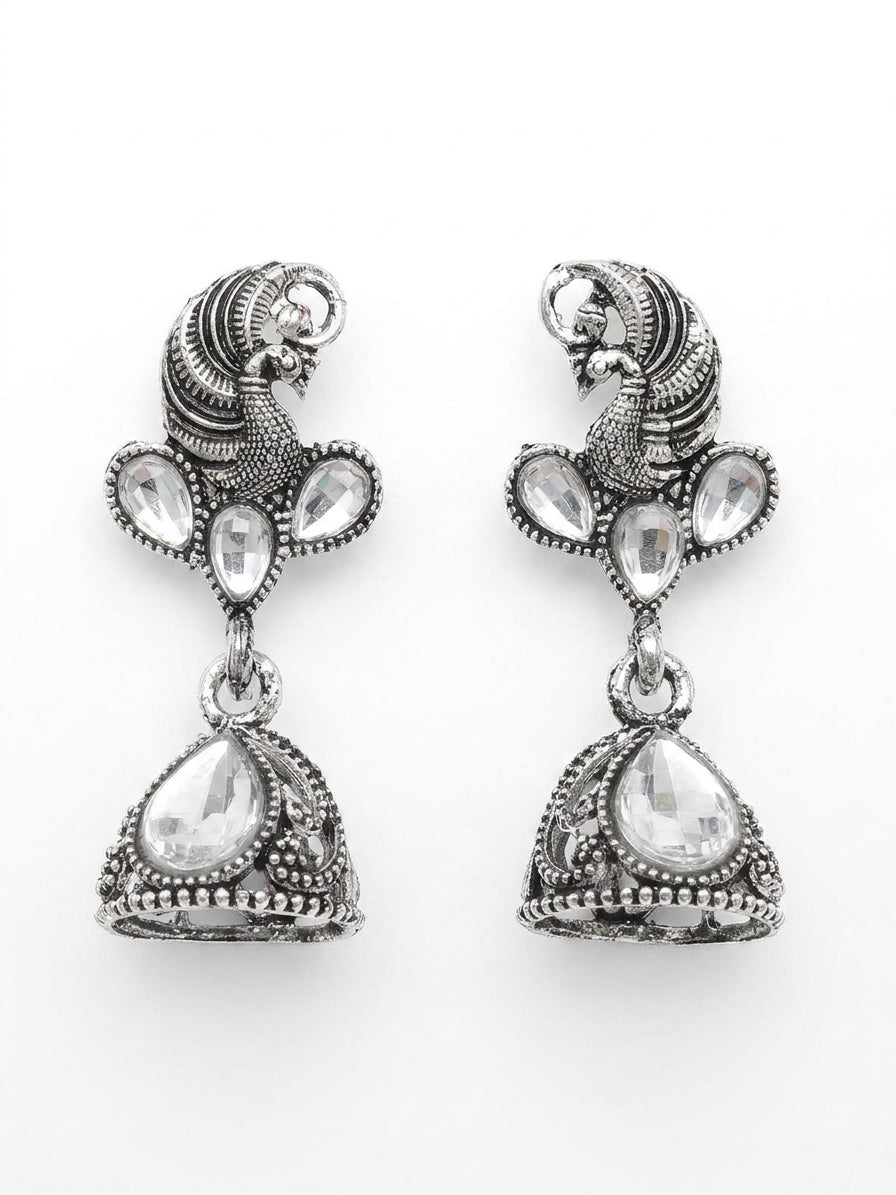 Oxidised silver peacock head CZ kundan trefoil and conical jhumka bell drop earrings in open dark mahogany wood jewellery box with navy blue velvet lining and gold crown logo – AureliaBlends ethnic earrings