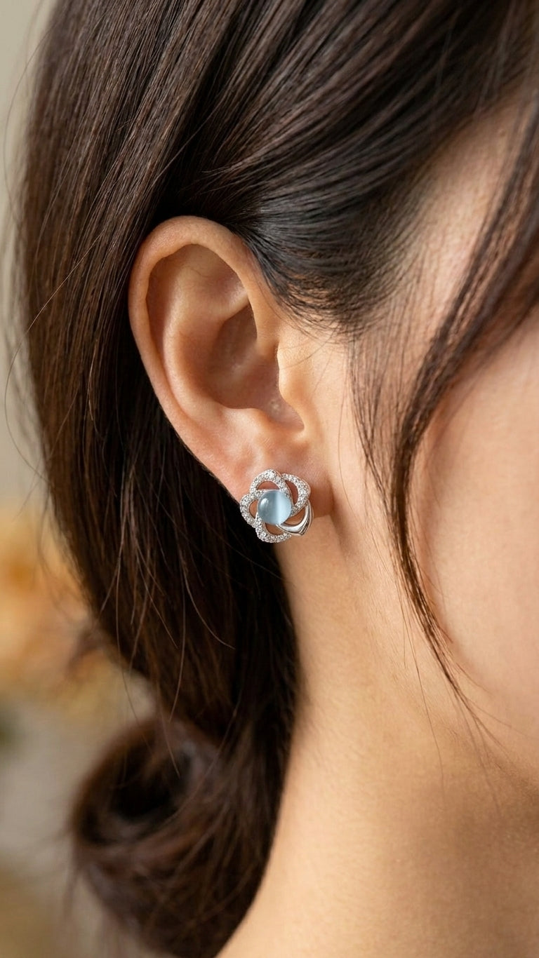 Silver pavé CZ swirl floral moonstone stud earrings in an open powder blue velvet gift box with ivory satin bow, baby’s breath, loose pearls and a ‘For You’ card on champagne satin – AureliaBlends
