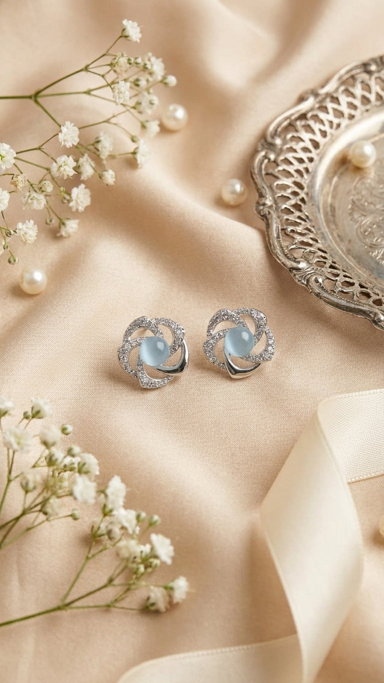 Silver pavé CZ swirl floral moonstone stud earrings in an open emerald green velvet gift box with ivory satin bow, baby’s breath, loose pearls and a ‘For You’ card on champagne satin – AureliaBlends