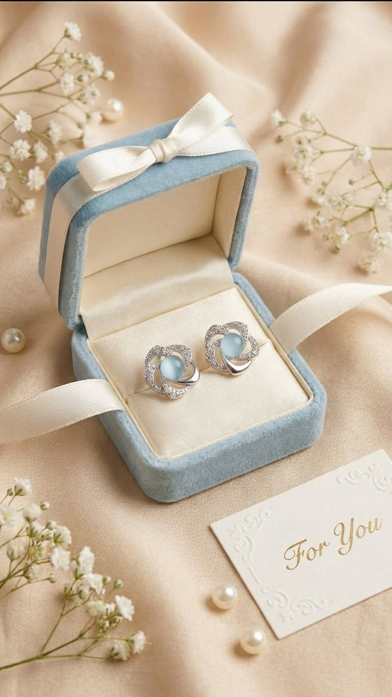 Silver pavé CZ swirl floral moonstone stud earrings in an open emerald green velvet gift box with ivory satin bow, baby’s breath, loose pearls and a ‘For You’ card on black satin – AureliaBlends luxury gift jewellery