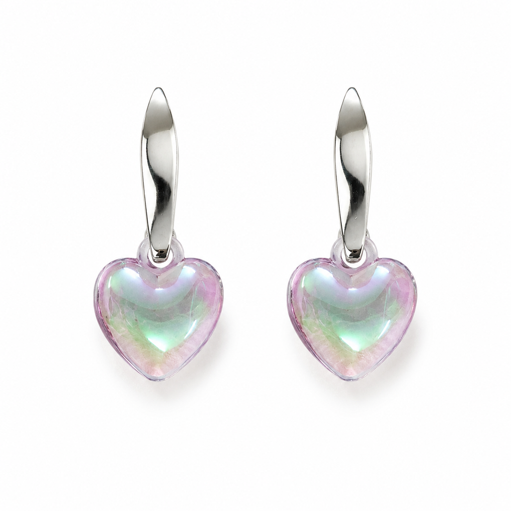 Model with elegant updo wearing silver twisted huggie hoop and puffy iridescent aurora heart crystal drop earrings showing blush pink mint green lavender shimmer against white background – AureliaBlends romantic earrings